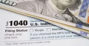 A close up of the irs form 1 0 4 0 and money