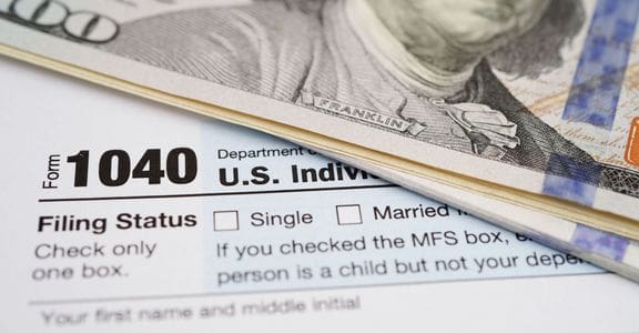 A close up of the irs form 1 0 4 0 and money