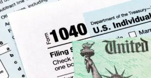 A close up of the irs form 1 0 4 0 and statue of liberty