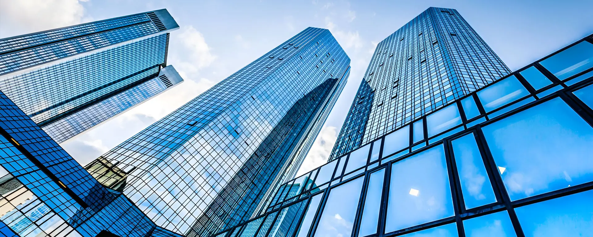 A view of two skyscrapers from below.