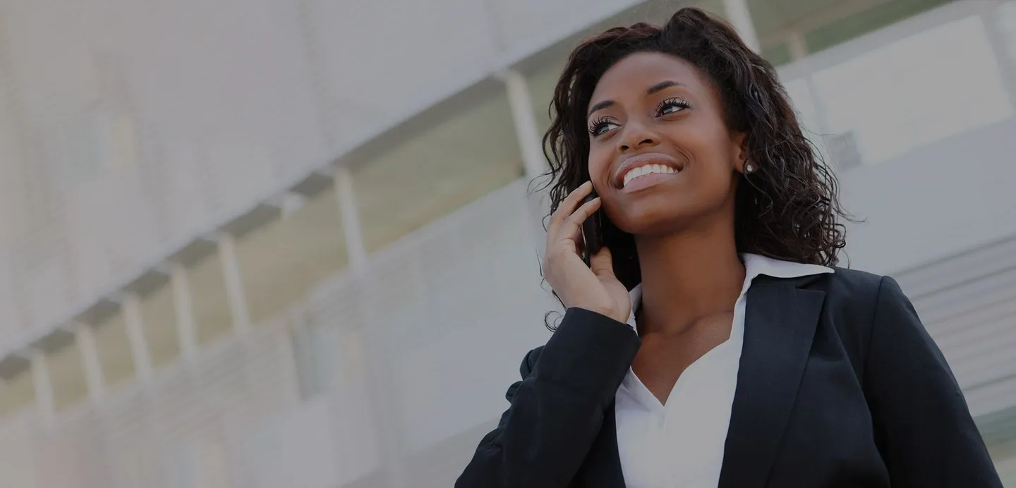 A woman talking on her cell phone outside.