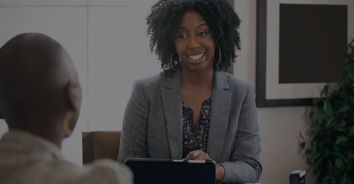 A woman sitting in front of a laptop.