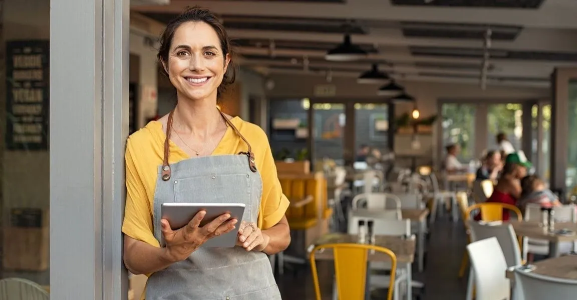 A woman holding an ipad in her hand.