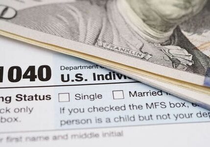 A close up of the irs form 1 0 4 0 and money