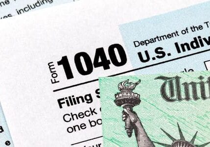 A close up of the irs form 1 0 4 0 and statue of liberty